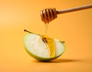 A slice of green apple is drizzled with golden liquid from a wooden honey dipper. The scene is set against a warm orange background