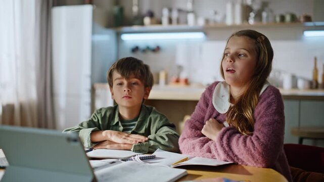 Girl listening online lesson raising hand answering question at home closeup