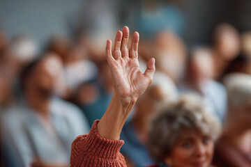 Focused Hand Raised in Auction House Amid Enthusiastic