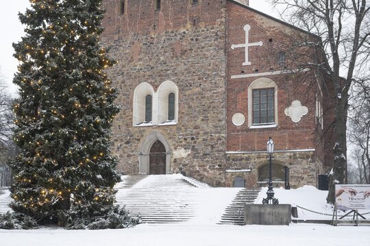 Christmas tree with fairy lights in front of stairs leading to the main portal, Turku Cathedral, Finnish Turun Tuomiokirkko, Swedish &Aring;bo Domkyrka, medieval cathedral, main church of the Evangelical Lutheran Church, wintery Turku, Finland