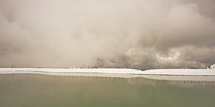 Another onset of winter in May, Riezler Alpsee, an artificially created lake, snow pond, feeds the snow cannons that completely snow the slopes of the Fellhorn and Kanzelwand cable cars, Allg&auml;u Alps, Vorarlberg, Austria