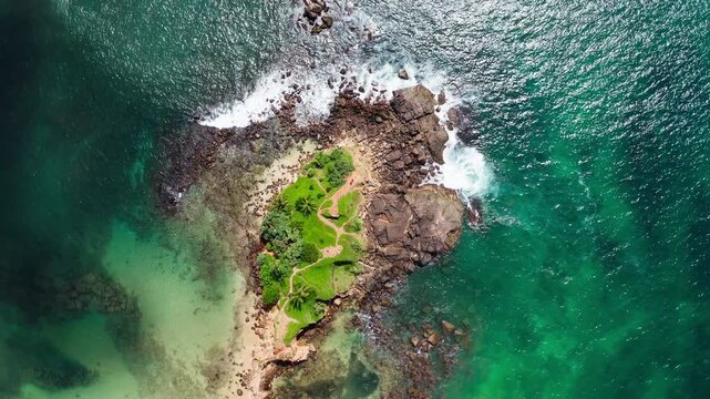 Parrot Rock Hill washed by Indian ocean waves flying drone beautiful Nature's landmark 4K video in Mirissa, Matara District on Sri Lanka. Exotic Asian countries and around the World traveling concept