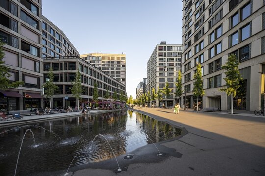 Office building, fountains and restaurants on Europaallee, in the evening light, Zurich, Switzerland
