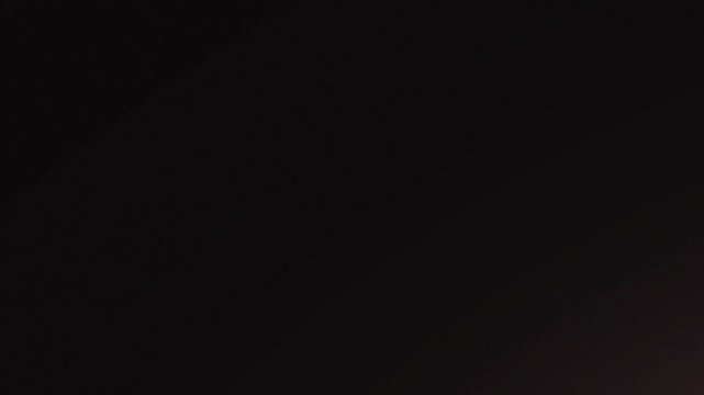 A stunning nebula fills the vast expanse of deep space with vibrant purple and pink hues.