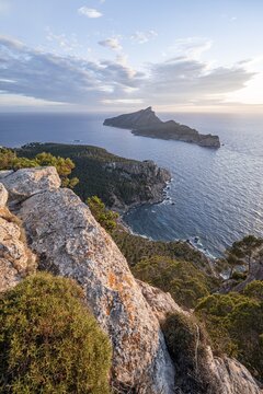 View of mountains and coast with sea, in the evening light, hiking to La Trapa from Sant Elm, at the back island Sa Dragonera, Serra de Tramuntana, Majorca, Spain