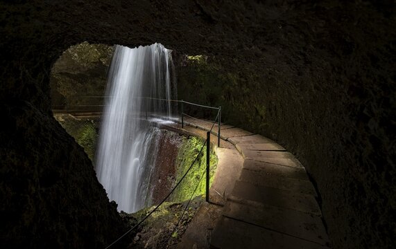 Hiking trail behind waterfall at Levada Nova, Waterfall Nova and Moinho in a gorge, long exposure, Ponta do Sol, Madeira, Portugal
