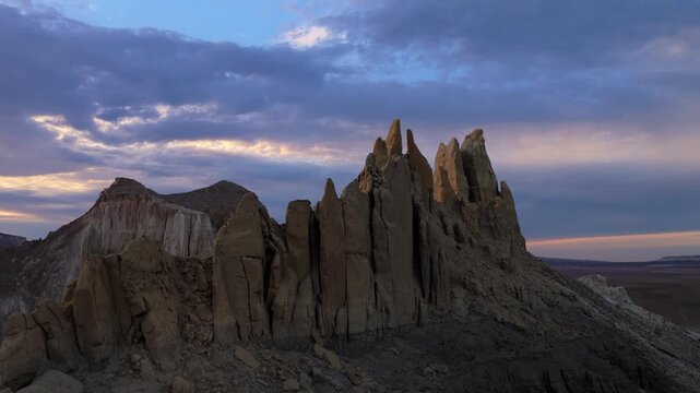 Aerial view of stunning rock formations under a dramatic sky, where hues of twilight paint a breathtaking landscape, Shetpe, Mangystau Region, Kazakhstan.