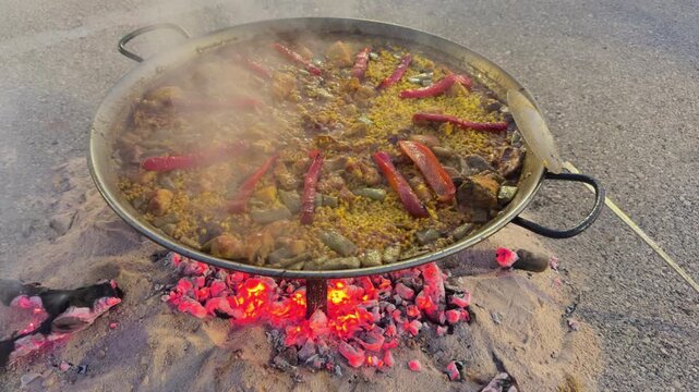 Valencia authentic paella cooking over firewood in paellera pan