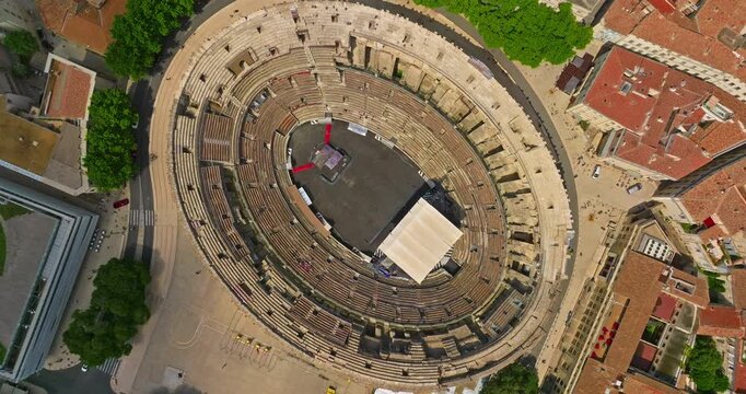 Aerial view of famous Arena of Nimes, France. Old Roman amphitheatre at sunset