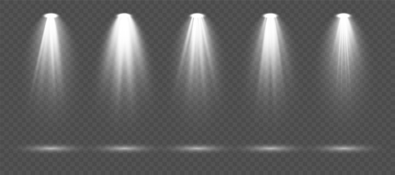 Realistic white spotlight set with dramatic illumination rays, soft gradients and glowing beam effects isolated on transparent background perfect for stage scenes, events and high-quality vector artwo