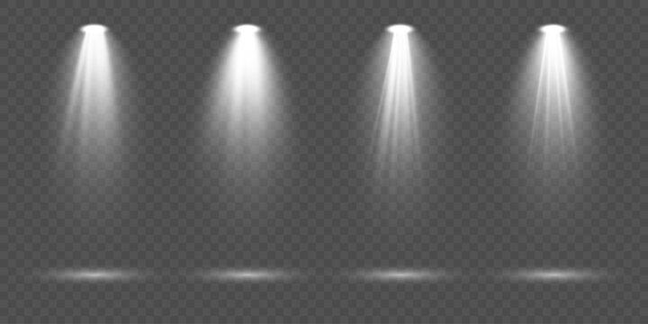 Set of white spotlights with powerful illumination beams and soft diffused rays isolated on transparent background perfect for stage lighting design, presentation highlights and professional vector gr