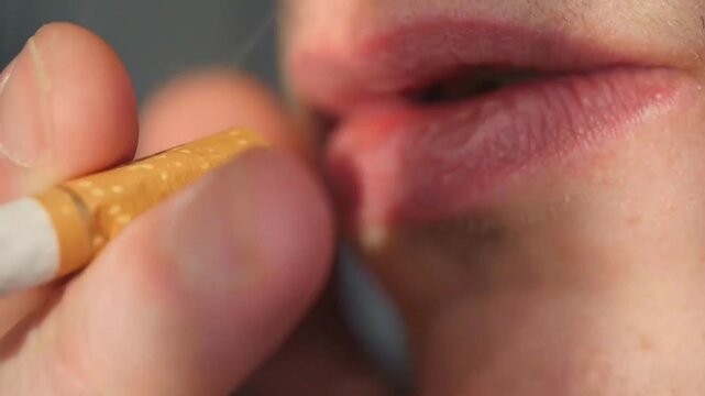 woman applying lip gloss on her lips