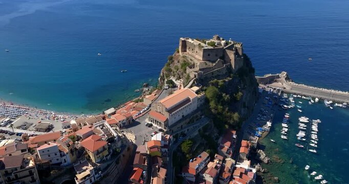 Aerial view of the main church and the Ruffo Castle located in the historic center of the town of Scilla, Calabria, Italy. It is a village located on a promontory overlooking the Mediterranean sea.