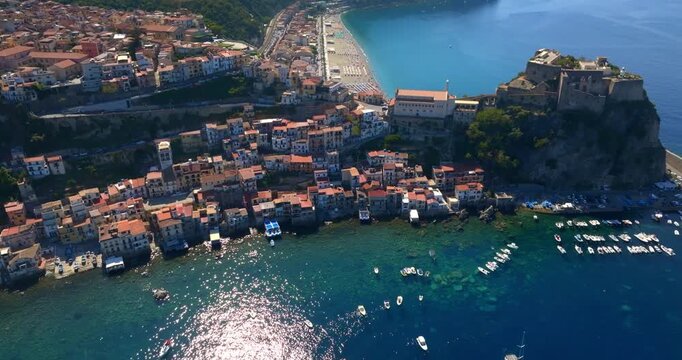 Aerial view of the town of Scilla, in the province of Reggio Calabria, Italy. The historic center and the hamlet of Chianalea are in the foreground. The town beach is in the background.
