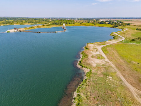 Aerial view of the expansive Strkovisko na Zidovkach gravel quarry, where turquoise waters meet the textured earth, Vysoka pri Morave, Bratislavsky kraj, Slovakia.