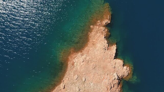 Aerial top down view of the rocky shores of Lake Potrerillos in Mendoza, Argentina