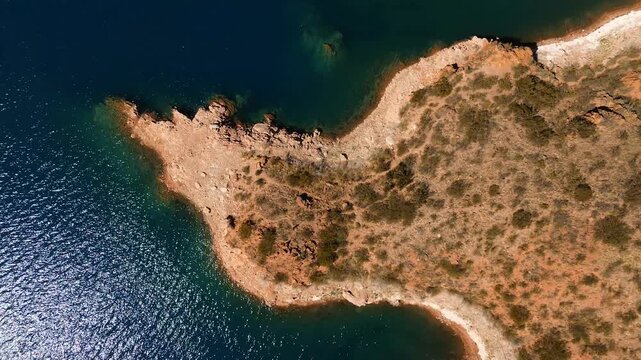 Aerial top down view of the rocky shores of Lake Potrerillos in Mendoza, Argentina