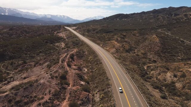 Aerial view of a tarmac road across the desert in Mendoza, Argentina.