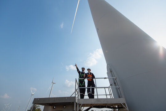 Engineers working on site in wind turbine farm, Wind turbines generate clean energy source, Eco technology for electric, industry environment.