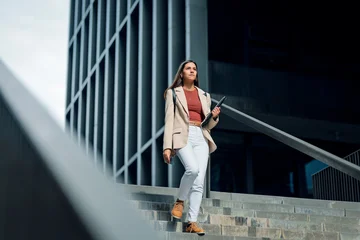 Fototapete Altes Krankenhaus Beelitz Elegant young businesswoman going down the street stairs.  © nenetus