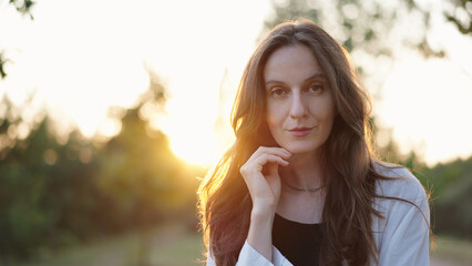 Portrait of a Beautiful Woman Outdoors at Sunset, Female Model Posing Looking at Camera With Hair...