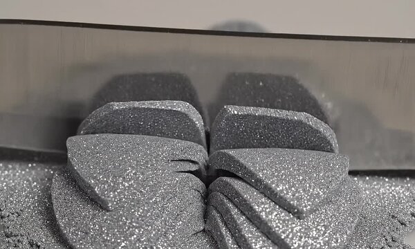 Close up view of hot wire cutting silver glitter foam material precisely