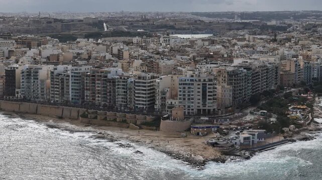 Aerial view of sideways panning of coastline of Sliema, Valetta, Malta