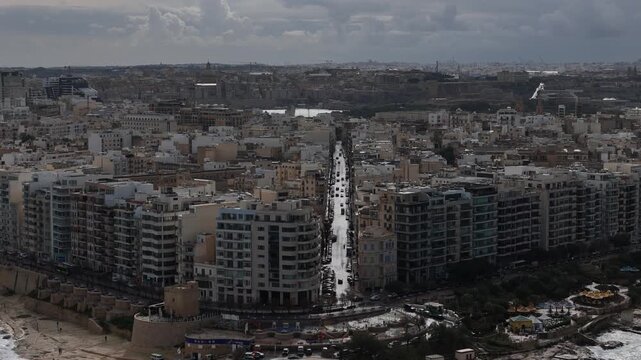 Aerial view of upwards reveal of neighbourhood of Sliema, Valetta, Malta
