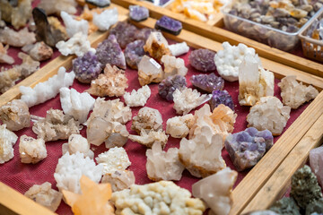 Stall filled with various precious and semi precious stones and crystals Altai Russia. Colorful collection of natural minerals for sale and display.