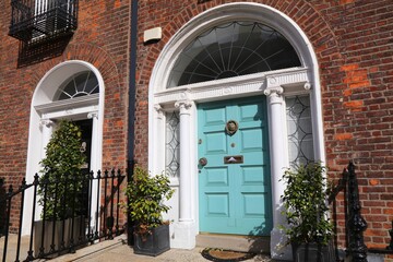 Georgian teal blue door in Clare Street in Dublin city, Ireland. Georgian architecture in southside Dublin.