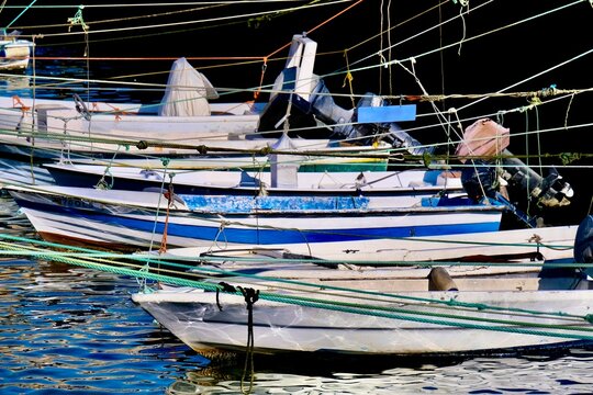 Moored fishing boats in the Fuseta Canal. It runs through the Ria Formosa Natural Park and provides access to the offshore island Ilha da Armona.