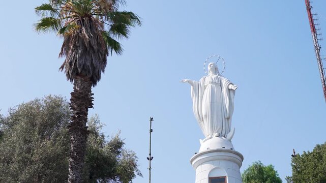 Majestic white statue of the virgin mary at the summit of san cristobal hill in santiago, chile