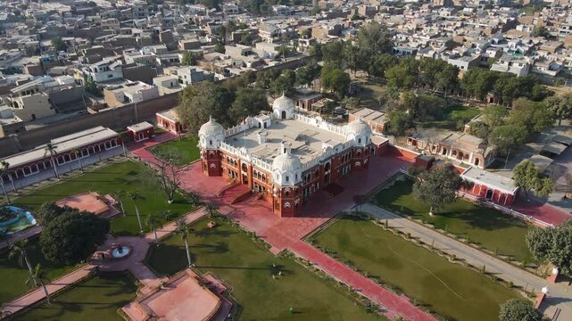 Aerial view of Barbar mahal bahawalpur, with its red brick architecture and white domes, set amidst green lawns and pathways, Bahawalpur, Punjab, Pakistan.