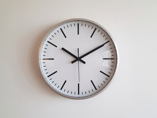 Modern minimalist wall clock showing 11:10 on white background