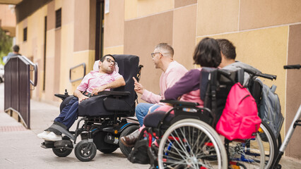 Group of adults with physical disabilities using wheelchairs and talking outdoors, advocating...