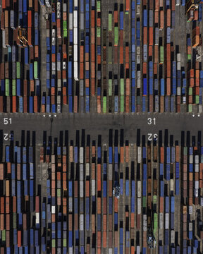 Aerial view of stacked shipping containers in a multitude of colors creating a geometric pattern, Barcelona, Spain.