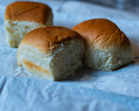Three rolls on a white napkin. 