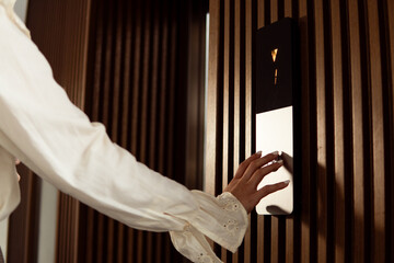 Woman's hand pressing elevator button in modern building © Djavan Rodriguez