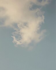 Fluffy White Cloud Drifting Over Clear Blue Sky During Daylight Hours