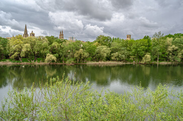 Ebro River cityscape in Logrono, Spain, under cloudy daytime sky