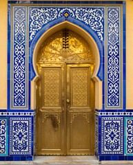Intricately Designed Golden Door with Colorful Tile Patterns in Moroccan Architectural Style
