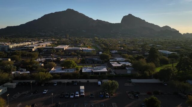 Paradise Valley, United States - 19 January 2026: Aerial view of Camelback Mountain looming over the Marriott Condominium and lush landscape at sunset.