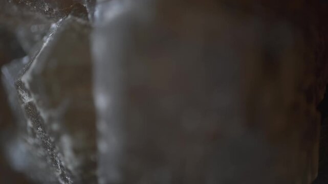 Macro video of hessonite garnet crystal from Dalnegorsk deposit. Translucent brown-orange mineral with internal inclusions and geometric faces