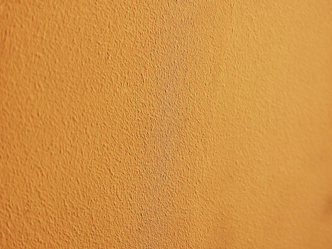 Orange bumped wall texture illuminated by light backdrop