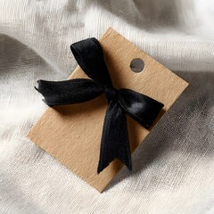 Square Brown Kraft Paper Tag Mockup with Elegant Feature &mdash; Branding Display gift box with ribbon on wooden background