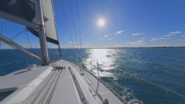 Valencia sailboat sailing on Mediterranean Sea with sun reflections