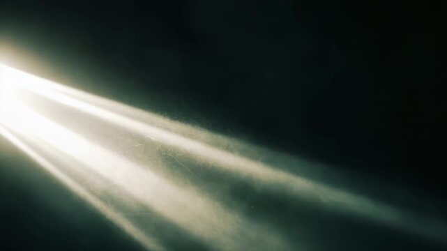 Light rays cutting through a smoky atmosphere or dust particles, creating a dramatic abstract background, representing concepts of hope, mystery, success, search, or spirituality