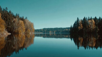 Obraz premium Lake reflecting autumn forest landscape