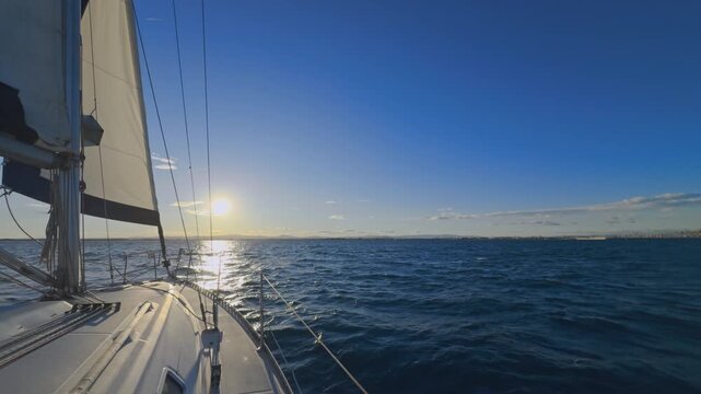 Valencia sailboat sailing on Mediterranean Sea with sun reflections