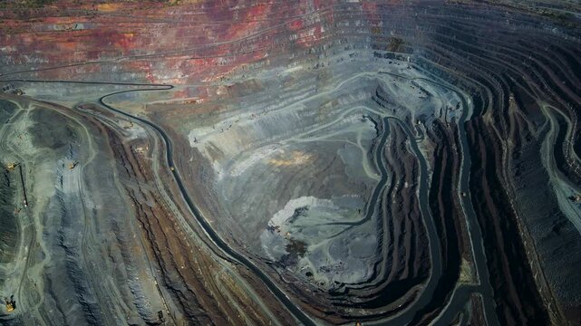 Iron ore mining, mineral deposits, excavation work, drone view.